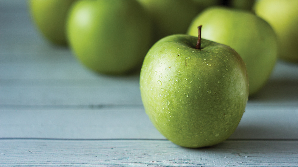 Those who eat organic apples, core and all, get 10 times the bacteria